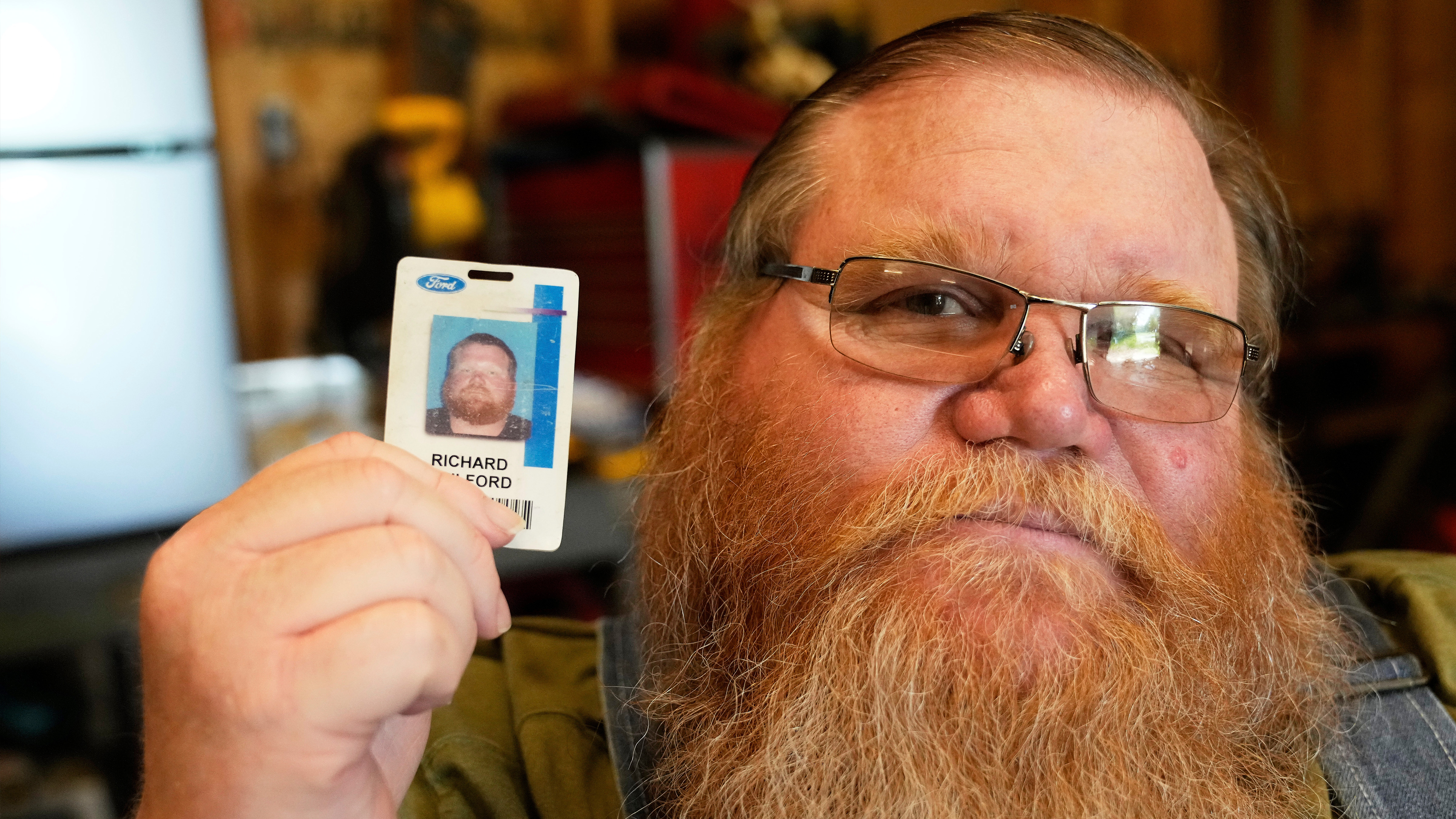 Richard Guilford poses for a portrait with an ID card from his recently recovered wallet that he lost 11 years ago Thursday, Aug. 14, 2025, in Petersburg, Mich. 