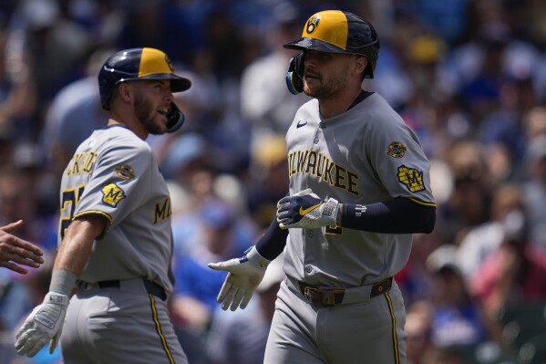 Milwaukee Brewers' Brice Turang (2), right, celebrates after hitting a two-run home run during the second inning of a baseball game against the Chicago Cubs, Thursday, Aug. 21, 2025, in Chicago. (AP Photo/Erin Hooley)