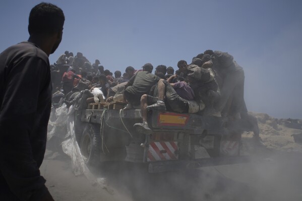 Palestinians hold onto an aid truck returning to Gaza City from the northern Gaza Strip on Tuesday, July 22, 2025. (AP Photo/Jehad Alshrafi, file)