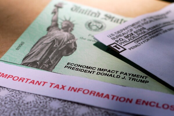 President Donald Trump's name is printed on a stimulus check issued by the IRS to help combat the adverse economic effects of the COVID-19 outbreak, April 23, 2020, in San Antonio. (AP Photo/Eric Gay, File)