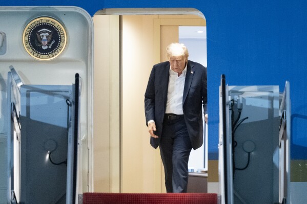 President Donald Trump walks to disembark Air Force One as he arrives at Joint Base Andrews, Md., early Saturday, Aug. 16, 2025, from a summit with Russian President Vladimir Putin in Anchorage, Alaska. (AP Photo/Manuel Balce Ceneta)