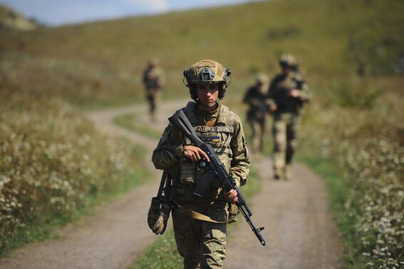 In this photo, taken on Tuesday, Aug. 19, 2025 and provided by Ukraine's 127th Separate Brigade of the Territorial Defence press service, soldiers aged 18 to 24 practice military skills on a training ground near Kharkiv, Ukraine. (Anatolii Lysianskyi/Ukraine's 127th Separate Brigade via AP)