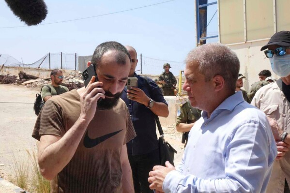 Salah Abu-Hussein meets Israeli hostage coordinator Gal Hirsch upon his return from detention in Lebanon to Israel on Thursday, Aug. 21, 2025 at the Rosh Hanikra border crossing. (Government Press Office via AP)