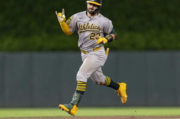Athletics catcher Shea Langeliers (23) celebrates as he rounds the bases after hitting a two-run home run in the 10th inning of a baseball game in Minneapolis, Minn., on Wednesday, Aug. 20, 2025. (Carlos Gonzalez/Star Tribune via AP)