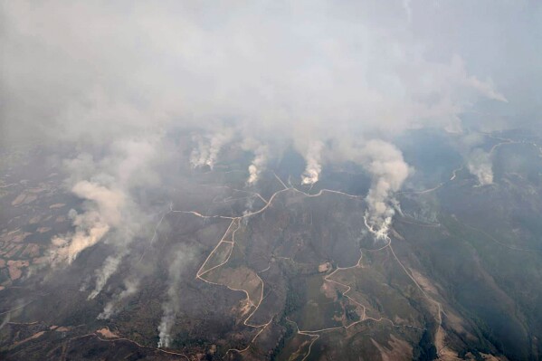 This recent photo taken from a French Canadair water bomber and provided Friday, Aug. 15, 2025 by the Securite Civile shows wildfire in Spain. (Securite Civile via AP)
