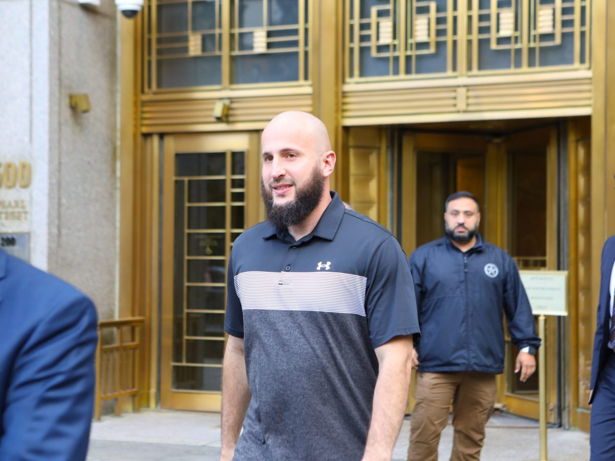 Mohamed Bahi walks out of the gold colored front doors of 500 Pearl street. The address can be seen on the left of the frame.